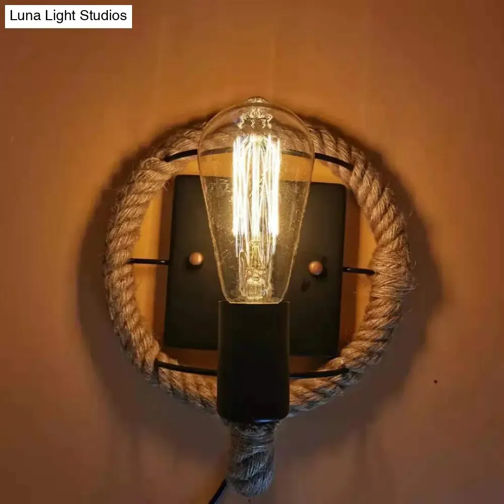 Rustic Indoor Wall Light with Wagon Wheel Design and Rope Shade